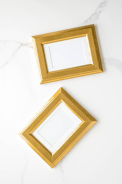 golden photo frame on marble, flatlay mockup - decor and mockup flatlay styled concept - Photo, Image