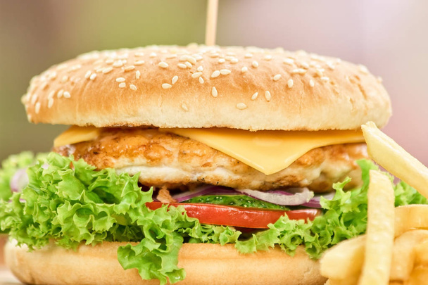 Closeup shot a tasty burger. Close-up freshly prepared cheeseburger. Fastfood in blurred background. - Photo, Image