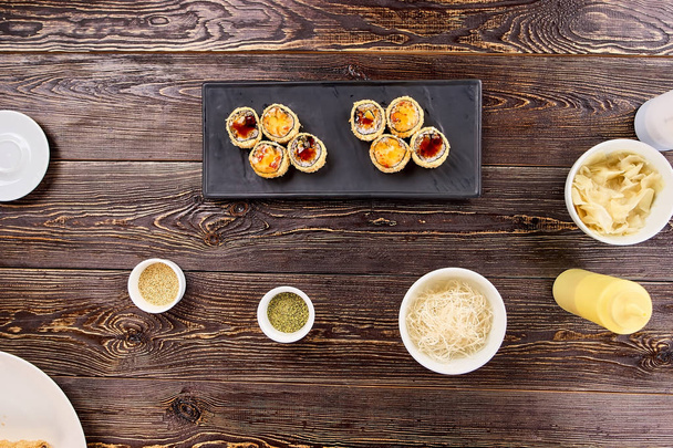 Delicious sushi rolls on black rectangle plate. - Zdjęcie, obraz