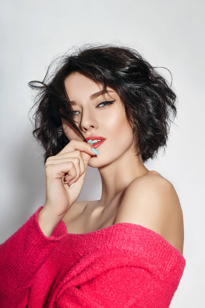 Naked sexy woman with short hair. Girl posing in a red sweater on a white background. Perfect clean skin, sexy Nude body of brunette woman. Skin rejuvenation and hydration - Zdjęcie, obraz