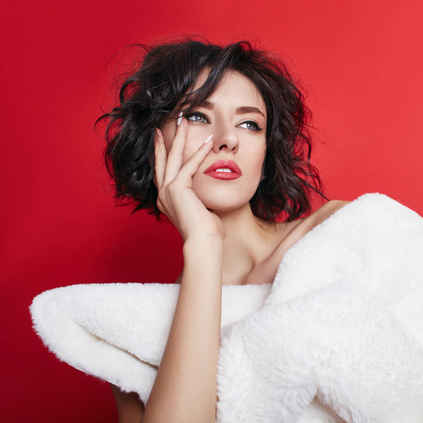 Naked sexy woman with short hair. Girl posing in a white jacket on a red background. Perfect clean skin, sexy Nude body of brunette woman. Skin rejuvenation and hydration - Foto, immagini