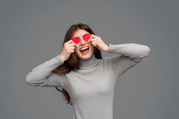 Excited lady with tiny hearts near eyes - Фото, изображение