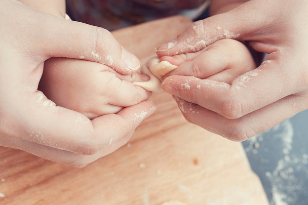 mom helps the child to sculpt dumplings - Photo, Image