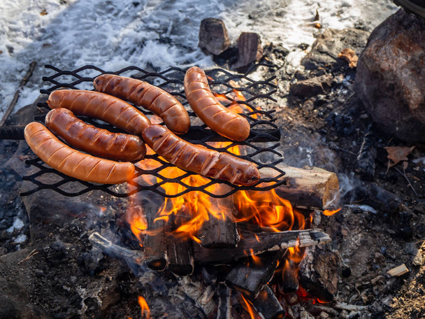Winter sausage barbecue in Lapland nature Finland - Fotó, kép
