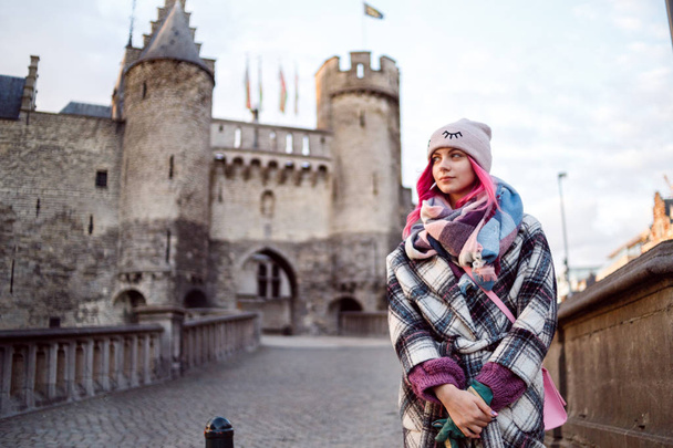 Young sexy girl with pink hair and beautiful face in coat near Antwerp castle or Palace - Φωτογραφία, εικόνα