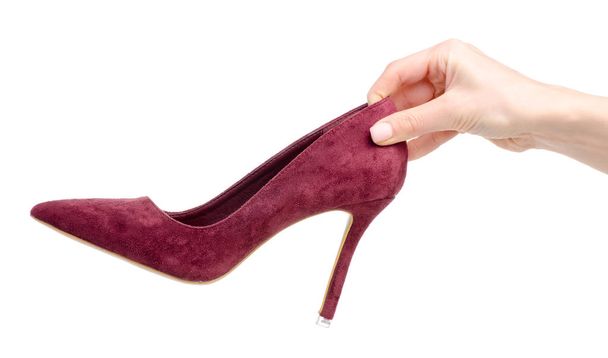 Female red suede high heels shoes in hand - Foto, Imagen