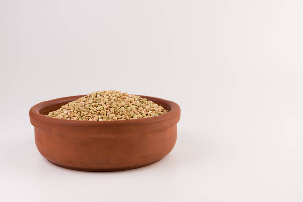 Natural fresh green buckwheat in bowl isolated on white background.  - Zdjęcie, obraz