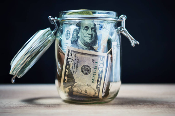 US Dollar bills in a glass jar. Saving money and investment concept  - Photo, Image