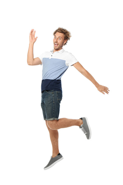 Young man in casual clothes jumping on white background - 写真・画像