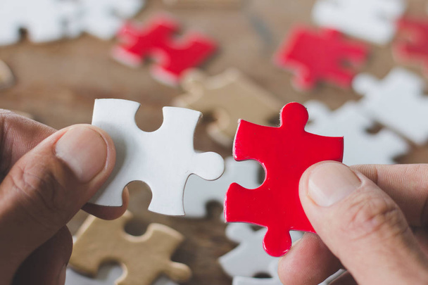 Business solutions, success and strategy concept. Businessman hand connecting jigsaw puzzle - Photo, Image