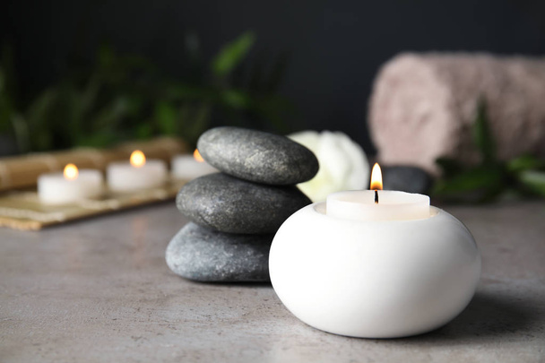 Spa composition with burning candle on table, space for text - Фото, зображення