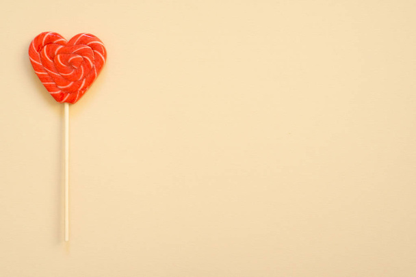 Red and pink lollipop. Candy in the form of heart. - Fotografie, Obrázek