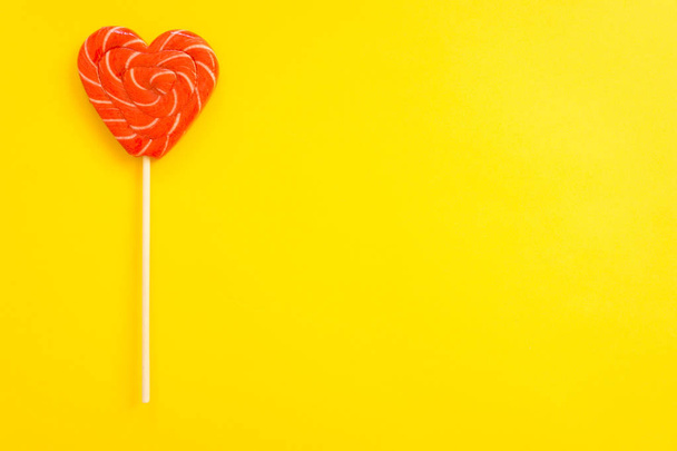 Red and pink lollipop. Candy in the form of heart. - Photo, image
