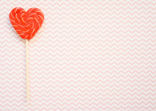Red and pink lollipop. Candy in the form of heart. - Foto, imagen