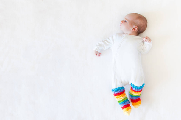 A small newborn boy lies on the bed. White background. - Fotó, kép