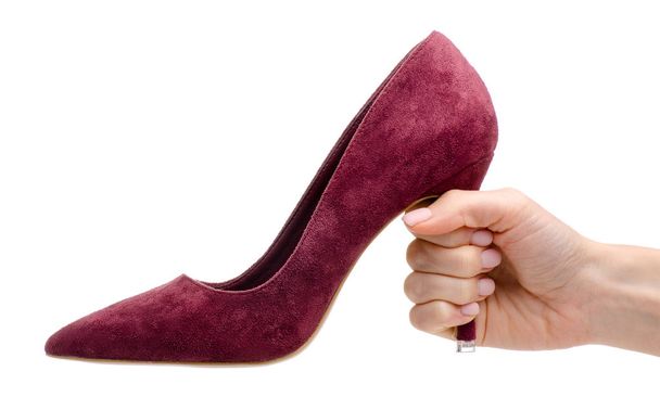 Female red suede high heels shoes in hand - Fotoğraf, Görsel