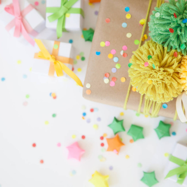 Bright gifts for a party, birthday or a new year. Confetti, stars, garlands, crackers. - Foto, afbeelding