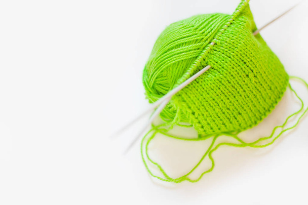 Knitted fabric green. Yarn for knitting green. White background. - Photo, Image