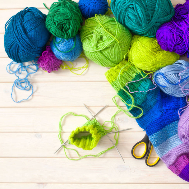 Closeup of basket with colorful yarn clews. Knitted Socks. - Fotó, kép