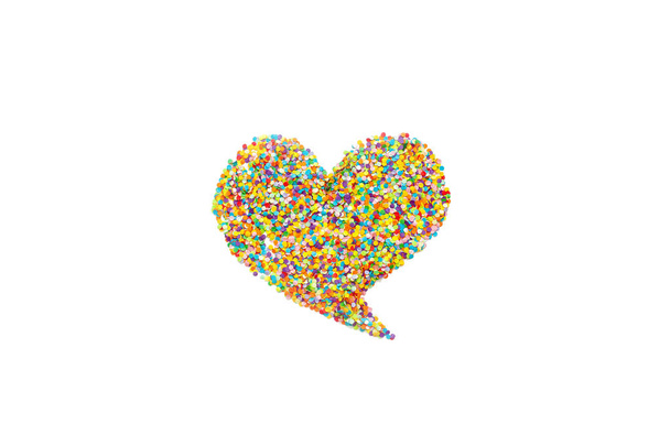 Heart made of colored confetti. Small circles of colored paper. White background. View from above. Colored heart. - Foto, afbeelding