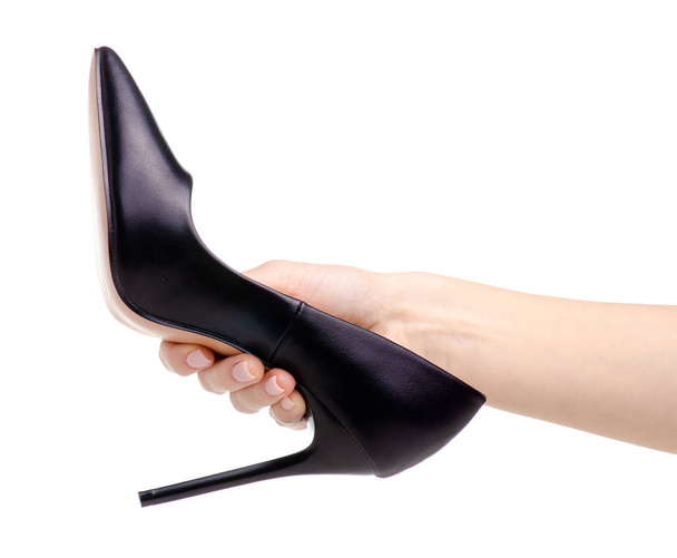 Female black leather high heels shoes in hand - Фото, изображение