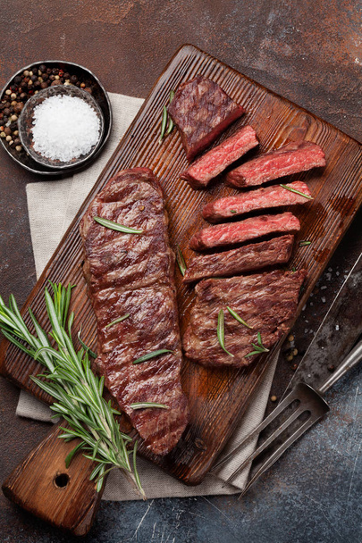 Top blade or denver grilled steak over cutting board. Top view - Photo, Image