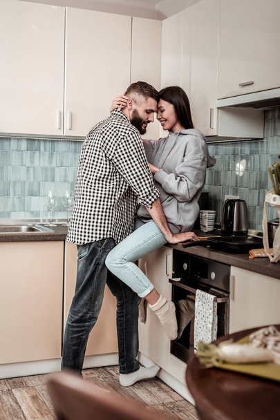 Cheerful woman feeling happy meeting her husband at home - Foto, Imagen