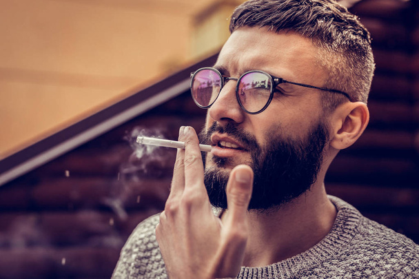 Portrait of a nice young man with a cigarette - 写真・画像