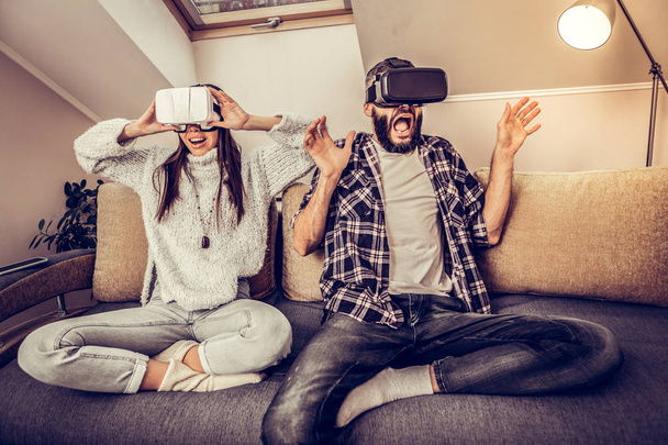 Emotional nice young couple experiencing virtual reality - Фото, зображення