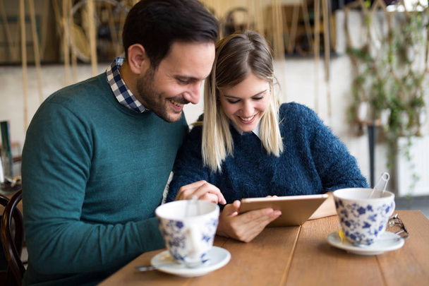 Young attractive couple on date together in coffee shop - Foto, immagini