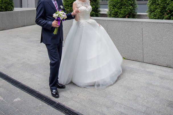 bride and groom are standing near the stairs - Valokuva, kuva