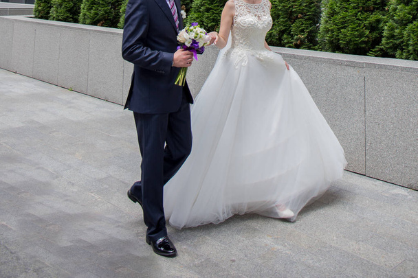 bride and groom are standing near the stairs - Valokuva, kuva