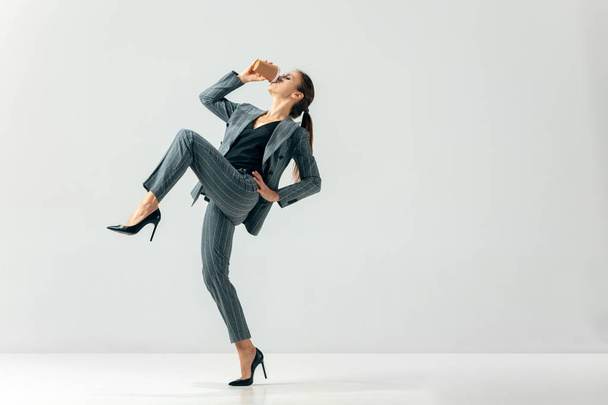 Happy business woman dancing and smiling isolated over white. - Foto, Bild