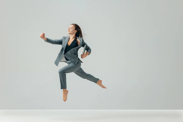 Happy business woman dancing and smiling isolated over white. - 写真・画像