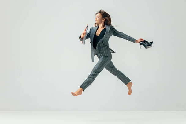 Happy business woman dancing and smiling isolated over white. - Photo, Image