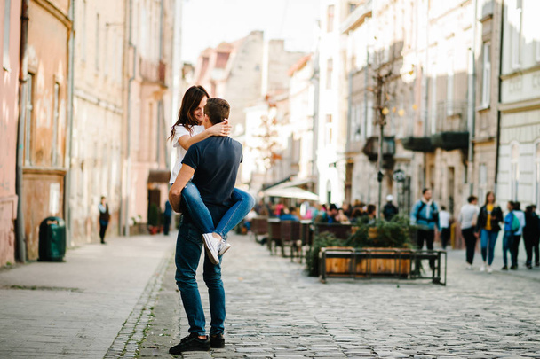 Young happy man and woman walking along streets of city - Foto, Imagem