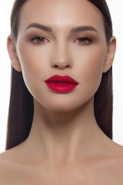 Close-up portrait of a beauty woman with red full lips, straight hair and perfectly clean skin. Daytime makeup, styling and soft care. Skin care in the spa salon or cosmetology, smooth eyebrows - Fotó, kép