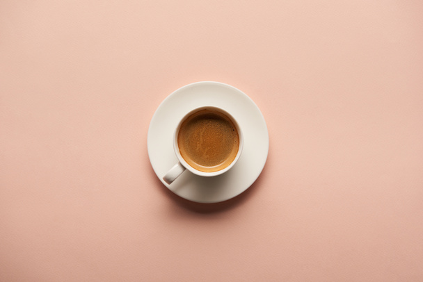 top view of tasty espresso in white cup on pink background - Zdjęcie, obraz