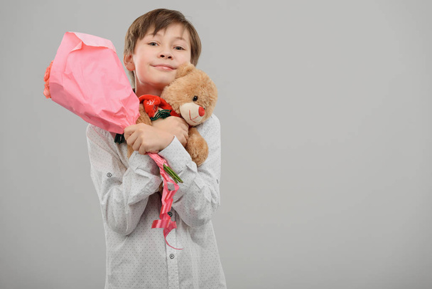 Boy with flowers and toy - Zdjęcie, obraz