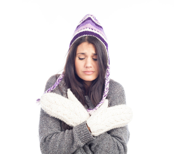 pretty brunette woman with a woolen Peruvian hat a sweater and gloves that has cold - Photo, image