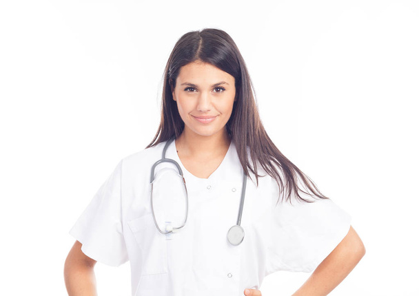 portrait of smiling nurse or brunette doctor in white coat with stethoscope - Foto, afbeelding