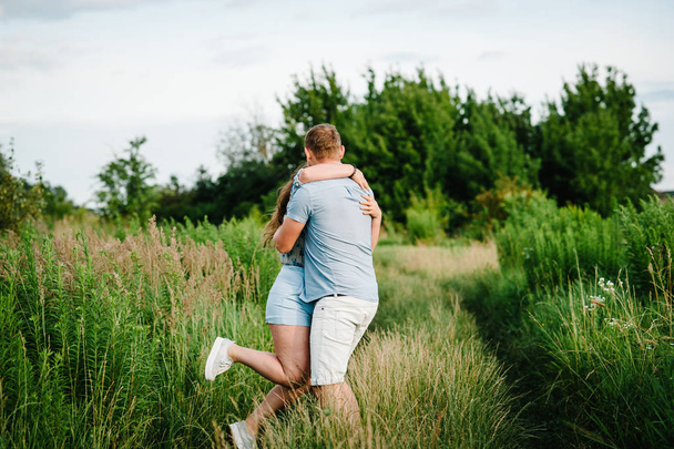 lovely family hugging in green summer countryside  - Fotó, kép