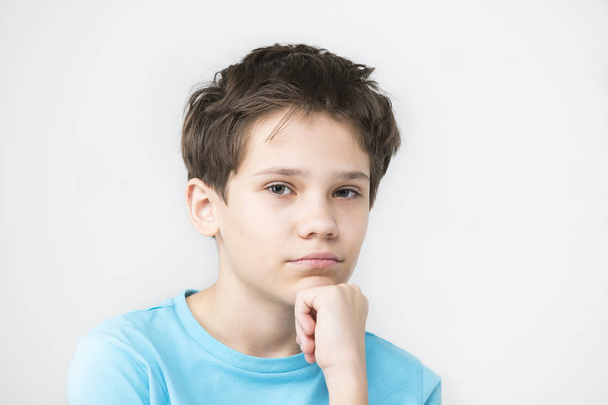 Portrait of an emotional boy on a white background. - Φωτογραφία, εικόνα