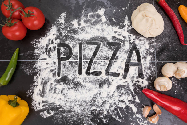 Ingredients for pizza, mushrooms, tomatoes, peppers garlic dough and flour - Fotoğraf, Görsel