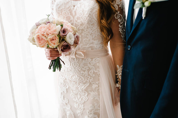 Elegant bride in luxury and groom with wedding bouquet - 写真・画像