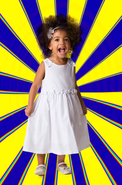 Portrait of a preschool cheerful child girl full length. Studio shot. Kid on geometric background - Foto, Bild