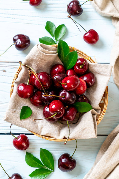 Fresh cherries in bowl  on wood background - Foto, Imagem