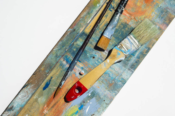Renkli arkaplan ve beyaz izole kopya alanı üzerindeki fırça ve spatula grubu. - Fotoğraf, Görsel