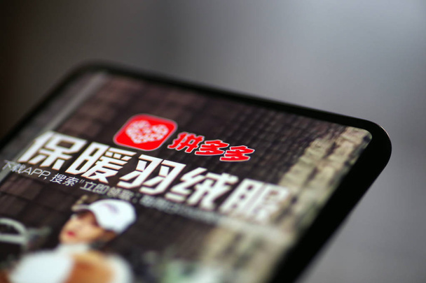 Usuário de celular chinês usa o aplicativo móvel da plataforma chinesa de e-commerce Pinduoduo em seu smartphone na cidade de Ji 'nan, província de Shandong, leste da China, 27 de julho de 2018
 - Foto, Imagem