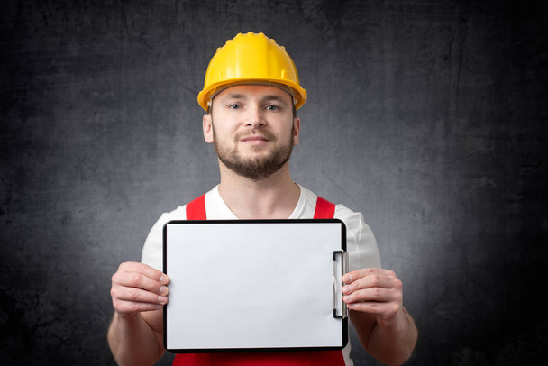 Worker showing blank clipboard - Photo, Image